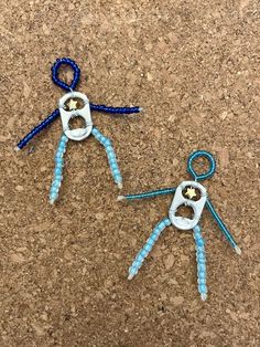 two blue and white scissors are on the ground