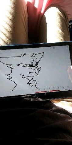 someone is drawing on their tablet while sitting down