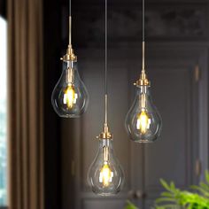 three light bulbs hanging from a ceiling