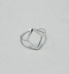 Rhombus ring, hollow, sterling silver, minimalist, geometrical, modern ring This rhombus ring is made to order from sterling silver wire. A comfortable minimalistic ring that you can wear every day. Height of rhombus: approx. 1,2 cm This ring is made to order; please make sure you choose your size. Convo me if your size is not available. Feel free to ask me if you don't know which is the right size for you. The ring above is not the exact one you will receive. Each one is handmade to order and m Modern Diamond-shaped Promise Ring, Sterling Silver Diamond-shaped Rings, Silver Sterling Silver Diamond-shaped Rings, Diamond-shaped Sterling Silver Rings, Sterling Silver Rings In Diamond Shape, Silver Sterling Silver Diamond Rings, Modern Sterling Silver Rings With Geometric Shape, Modern Sterling Silver Rings With Geometric Design, Modern Geometric Sterling Silver Rings