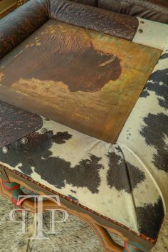 a cowhide covered table with an animal print on it