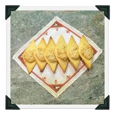 four pieces of cheese are on a paper napkin with black border around the edges,