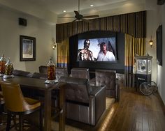 a living room filled with furniture and a flat screen tv mounted to the side of a wall