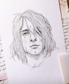 a drawing of a man with long hair on top of a piece of paper next to some writing