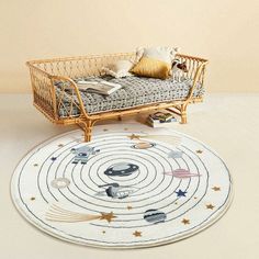 a baby bed and rug in the shape of an outer space theme with planets on it