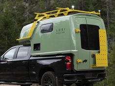 the truck is parked on the side of the road with its roof rack attached to it