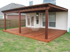 a large wooden deck in front of a house