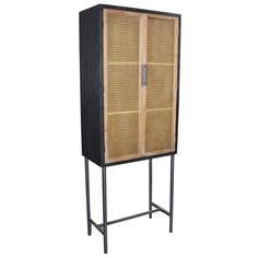 a tall wooden cabinet sitting on top of a metal stand with an iron frame and wicker doors