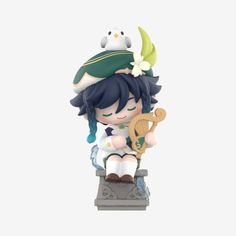 an anime figurine is sitting on top of a small statue with a bird perched on it's head