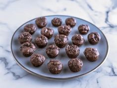 a plate filled with chocolate cookies on top of a marble counter