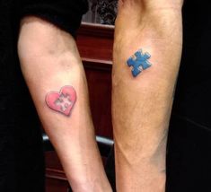 two people with tattoos on their legs and one has a puzzle piece in the shape of a heart