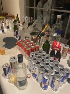 a table topped with lots of different types of bottles and glasses next to each other