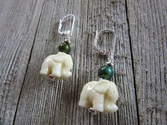 Stuck on what to get your animal-loving friend? These gorgeous elephant earrings are sure to be a delight! These boho beauties are carefully carved with immense detail. Their creamy off-white color will match any outfit and bring a little liveliness that tradition beads may lack. Above the elephants are color changing beads, that add another fun detail to these stunning earrings. Their wide array of colors is perfect for the person that just can't decide which earrings to wear. This way you or a Zen Aesthetic, Elephant Colour, Elephant Parade, Elephant Earrings, Boho Beauty, Elephant Lover, Original Gifts, Animal Earrings, Feather Necklaces