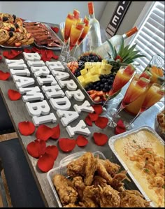 an image of a birthday party with food and drinks on the table in front of it