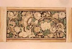 an intricately decorated wall panel with flowers and leaves on the border, painted in white