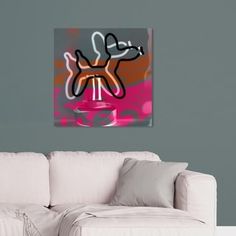 a living room with a white couch and a painting on the wall above it's head