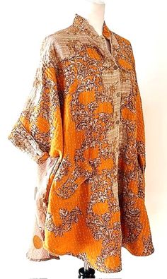 This version of the Tunic Top is fresh, comfortable, and stylish. Move over classic button downs, tunics are taking over! Kantha style stitched cotton creates interest and elevates the tunic. A-line cut is roomy, falling just below the hip. Flattering. Mixed complimentary print introduces several colors without being busy or cluttered. Each tunic is unique and handmade. This billowy tunic features a crepe panel in the back, functional front button placket. Front center bib is the focus of the tu Bohemian Tunic For Fall Daywear, Short Sleeve Tunic For Daywear In Fall, Short Sleeve Tunic For Fall Daywear, Spring Cotton Tunic With Buttons, Orange Long Sleeve Kurta For Spring, Cotton Tunic With Buttons For Daywear, Fall Tunic Kaftan, Oversized Bohemian Tunic For Daywear, Oversized Tunic Kaftan For Fall