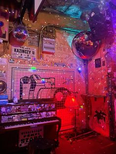 a room filled with lots of musical instruments and disco balls hanging from the ceiling above