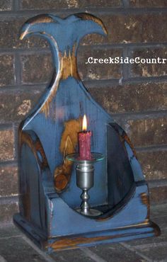 a candle is lit inside of a blue vase