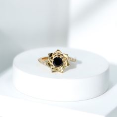 Product Details Show off your personal fashion with the exquisite Black Onyx Gold Floral Ring, adorned with dazzling Round Shape Black Onyx and Diamond stones. This stunning Bypass Flower Engagement Ring is a one-of-a-kind piece that any woman would love to wear. Product Information SKU SHP-RINGS0821192899 Width 5 mm Height 11.5 mm Weight 2.48 gm (Approximate) BLACK ONYX INFORMATION No.of Stones 1 Pieces Total Weight 0.45 Carat (Approximate) Dimension(approx) Round-5X5 mm-1 Pcs Color Black Cut Brilliant Shape Round Setting Type Prong-Setting Quality Grade AAA DIAMOND INFORMATION No.of Stones 18 Pieces Total Weight 0.23 Carat (Approximate) Dimension(approx) Round-1.20X1.20 mm-14 PcsRound-1.30X1.30 mm-2 PcsRound-1.40X1.40 mm-2 Pcs Color HI Cut Brilliant Shape Round Setting Type Prong-Setting Flower Engagement, Flower Engagement Ring, Floral Ring, 18k Yellow Gold Ring, Diamond Flower, Gold Floral, Diamond Stone, Yellow Gold Rings, Black Onyx