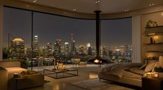 a bedroom with a view of the city at night