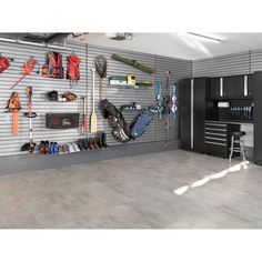 a garage with tools and equipment hanging on the wall