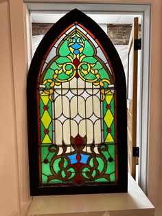 a stained glass window in the corner of a room