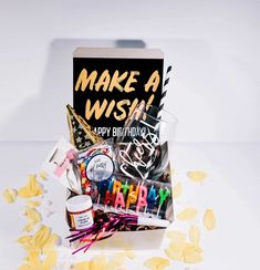 a greeting card with the words make a wish on it next to confetti