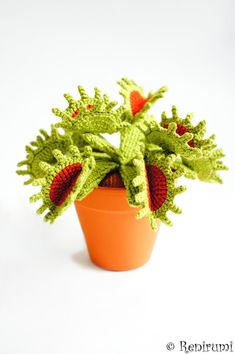 a crocheted potted plant sitting on top of a white table