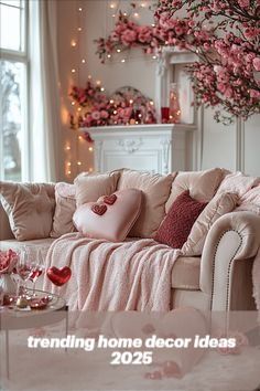 a living room filled with lots of furniture and pink flowers on the wall behind it