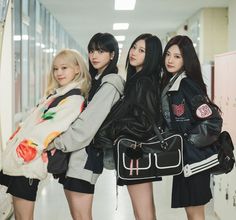 three girls are standing in a hallway with backpacks on their shoulders and one girl is holding a handbag