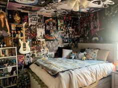 a bed room with a neatly made bed and lots of posters on the wall