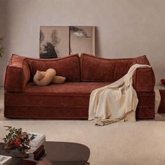 a living room with a couch, coffee table and pictures on the wall