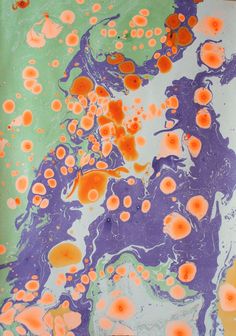 an abstract painting with lots of orange and pink dots on it's surface,