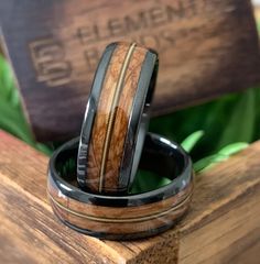 Material(s): Ceramic, Guitar String, Oak Wood Diameter: 8mm Color(s): Black, Brown Warranty: 1 year warranty Return Policy: 30 day return policy Processing Time: 3-5 business days Comfort Fit About This Ceramic Guitar String Ring Crafted from black ceramic, a lightweight and hypoallergenic alternative to metal rings, this men's wedding band is as strong and as unwavering as your love. This ring sings a tune with an authentic whiskey barrel oak wood and an elegant guitar string inlay. Inspired by Mens Ceramic Wedding Bands, Ceramic Guitar, Guitar String Ring, Guitar Wedding, Guitar Ring, String Ring, Ceramic Wedding, Black Tungsten Wedding Band, Unique Mens Rings