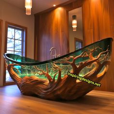 a bathtub that is sitting on the floor in front of a window with trees painted on it