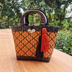 Introducing our handmade Thai straw bags, crafted with love and care by skilled artisans in Thailand. Each bag is made from high-quality, sustainable materials and features a beautiful woven design that is unique to each piece. The first thing you'll notice about our bag is the handcrafted wooden handle from Chiangmai. Made by skilled artisans using locally sourced wood, the handle adds a touch of rustic elegance to the design. It's both comfortable to hold and visually striking, making it the p Eco-friendly Orange Rectangular Straw Bag, Artisan Crochet Bag With Weaving, Eco-friendly Weaved Straw Bag For Travel, Eco-friendly Woven Straw Bag For Travel, Rectangular Straw Bucket Bag For Market, Eco-friendly Palm Leaf Bag With Open Weave, Eco-friendly Woven Straw Travel Bag, Eco-friendly Straw Travel Bag With Weaving, Eco-friendly Woven Bucket Bag With Top Handle