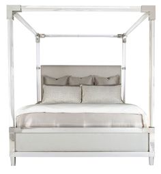 a white four poster bed with pillows and sheets on it's headboard, in front of a white background