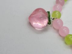 Made with 8 mm natural pink and green chalcedony beads and a resin peach charm. Bracelets are made with stretchy elastic string to fit more sizes. Due to the nature of bracelets handmade with natural crystal beads, some variation in color/sizing/design is to be expected. If you like this bracelet, and want something similar but slightly different? Just message me and we can discuss a custom listing! Pink Beaded Stretch Bracelet For Healing, Pink Gemstone Beads Charm Bracelet, Pink Rose Quartz Stretch Bracelet With 8mm Beads, Pink Hand-strung Charm Bracelet For Gift, Adjustable Pink Charm Bracelet With 8mm Beads, Adjustable Pink Rose Quartz Stretch Bracelet, Spiritual Pink Beaded Hypoallergenic Bracelets, Spiritual Pink Charm Bracelet With Round Beads, Adjustable Pink Stretch Bracelet With Gemstone Beads