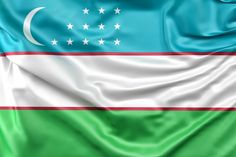 the flag of uzbekistan is waving in the wind