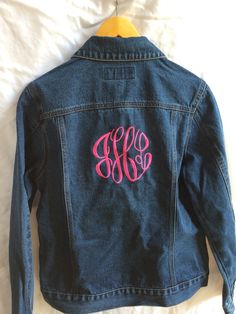 This denim jacket is the ultimate in preppiness! Whether this jacket is for you or for someone special on your list, it is sure to be a "WOW" piece. With the 6" monogram on the back of the jacket, you will stand out in the crowd! Jacket specs: -13.75-ounce, 100% stonewashed indigo denim  -Gently contoured silhouette  -Two button-through flap chest pockets  -Button cuffs  -Front pockets  Monogram options: Currently, I am only offering the fancy circle monogram shown in the picture. Please list in order of appearance EX:  j T m    (Joyce Marie Thomas) Thread colors: I have just about any color -- just ask!! Thank you for viewing! Customizable Denim Jacket For Fall, Fitted Cotton Outerwear With Letter Print, Customizable Cotton Denim Jacket For Fall, Fitted Denim Jacket With Custom Embroidery For Fall, Fitted Denim Outerwear With Letter Print, Fitted Fall Denim Jacket With Letter Print, Customizable Denim Outerwear For Fall, Customizable Cotton Fall Outerwear, Customizable Long Sleeve Denim Jacket