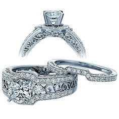 two wedding rings with diamond accents on each side and an engagement ring in the middle