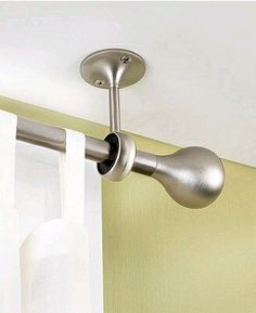 a close up of a curtain rod in a room