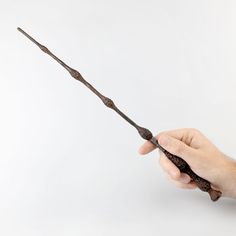 a hand is holding an old fashioned wand