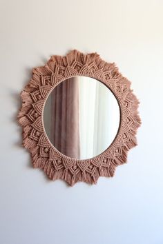 a round mirror hanging on the wall