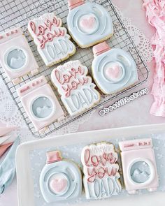 some cookies that are sitting on a tray next to each other with the words i love you dad written on them