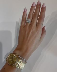 a woman's hand with two rings on it and a diamond ring in the middle