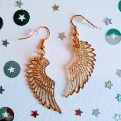 Delicate and under stated, these gold pegasus wing drop earrings are both durable and light as a feather! Hand etched in gold, the design features a feathered wing pattern.  As each pair is hand made no one is quite the same making them unique. Finished with gold plated ear wires and rubber earring backs. All my earrings are nickel free and hypoallergenic. Presented in a stylish, recycled, navy blue, cardboard gift box. All orders are shipped with Royal Mail standard 1st class. Comfy Fall Sweaters, Wing Pattern, Gold Wing, Cardboard Gift Boxes, Vintage Baby Clothes, Bridesmaid Gift Boxes, Travel Jewelry Box, Gem Earrings, Mixed Metal Jewelry