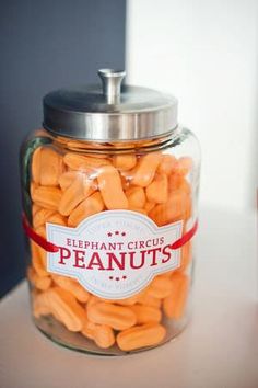 a glass jar filled with carrots sitting on top of a counter