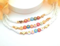 Child Name Necklace Color beads necklace gift for toddler girl jewelry for birthday Christmas gift letter bead necklace Kids name necklace This darling name necklace is so sweet, colorful and surely will make a perfect birthday gift, Christmas gift or and every day favorite accessory  100% made to order and handcrafted with excellence and precision into a beautiful, personalized name necklace that is so special and perfect for gift giving. Arrives in a white gift box with a bow ready for gifting. The colorful beads are carefully chosen to form a random color design for a personalized style. We use strong stretch cord to string the beads on. Because this necklace is a stretchy it does not require a clasp which makes this beautiful, dainty, personalized name necklace easy to put on and easy Playful Letter Beads Jewelry As Gift, Cute Beaded Necklace With Letter Beads For Birthday, Personalized Playful Adjustable Necklace, Customized White Necklace For Birthday Gift, Personalized White Necklace For Birthday Gift, Playful Letter Beads Jewelry Gift, Playful White Beaded Necklaces For Birthday, Personalized Adjustable Playful Necklaces, Playful Beaded Necklace With Letter Beads For Gift